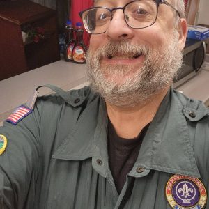 Tom Coonradt in a green venturing uniform smiling